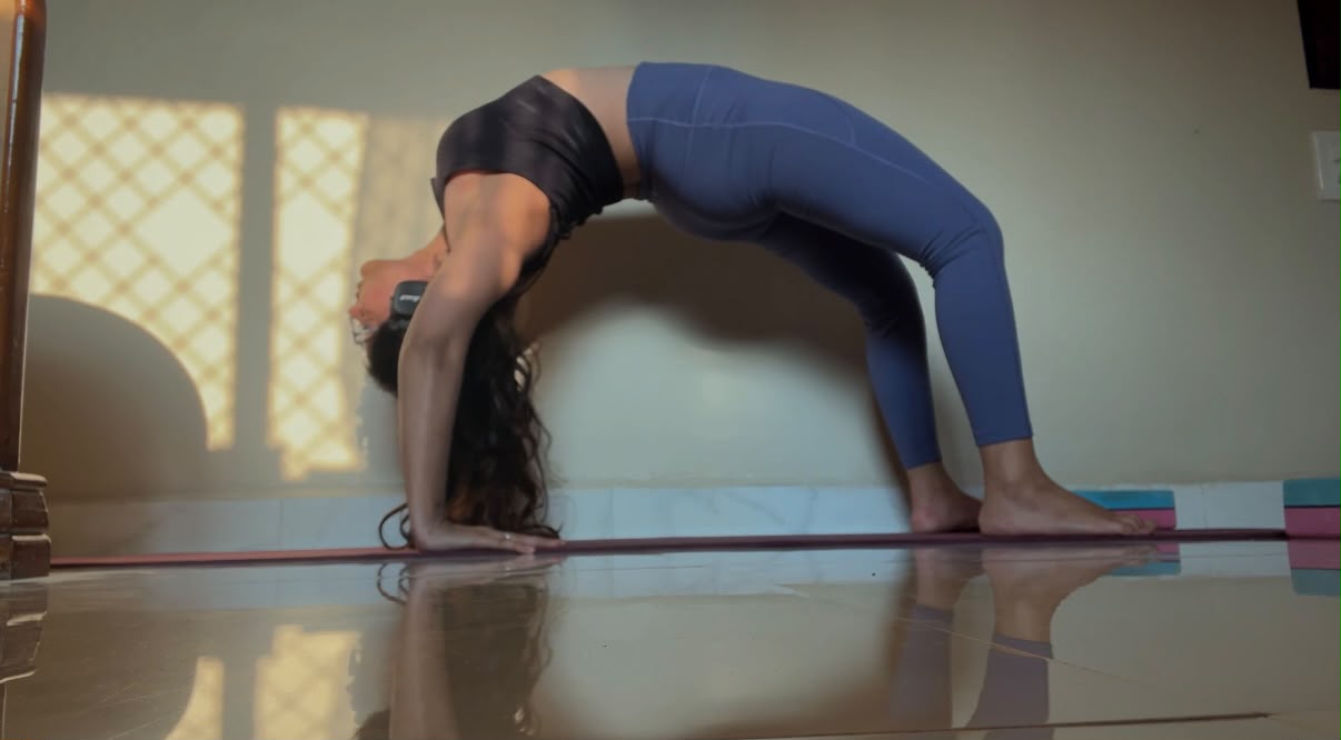 Shruti practising wheel pose